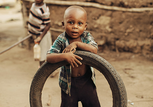 Keniaanse jongen met autoband