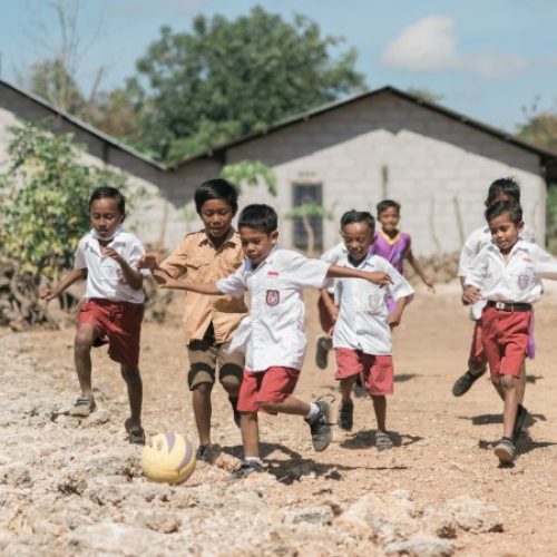 Kinderen uit Indonesië voetballen op straat.