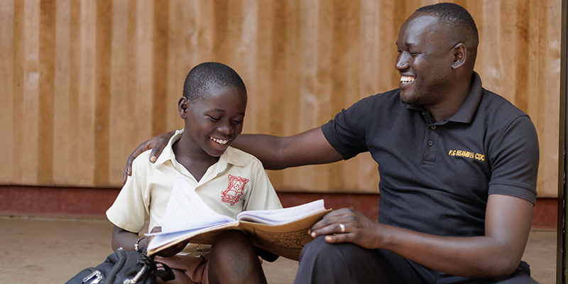 Moses heeft zijn hand op de schouders van Jordan en lacht.